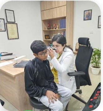 Dr. Aashima Chopra examining a young patient's ear at ENT Care Clinic